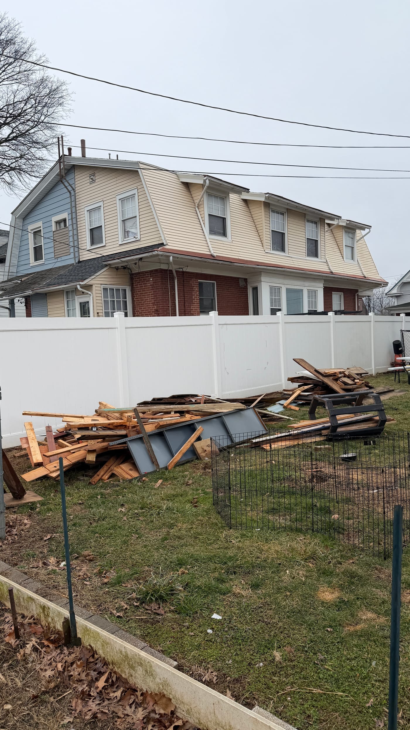 Large pile of demolition debris in a residential backyard