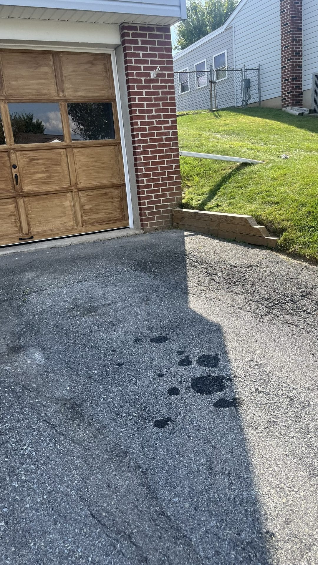 Clean driveway by the same brick garage after removal